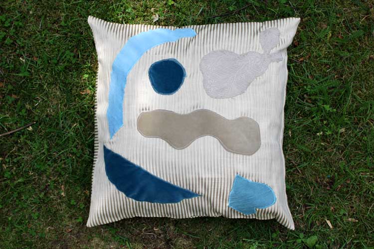Silver-throw-pillow-For-Laatumeininki-Kierratyskeskus-office-table-hands-setup-Susanna-Nousiainen