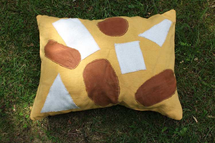 Yellow-throw-pillow-For-Laatumeininki-Kierratyskeskus-office-table-hands-setup-Susanna-Nousiainen